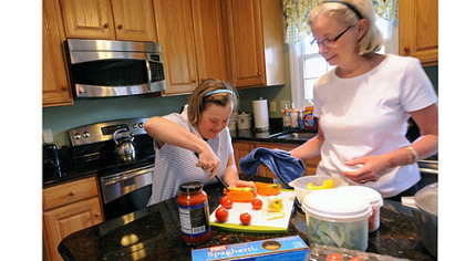 Marisa Murray, left, 38, and her mother, Nancy,  work together preparing veggies for their dinner salads in the kitchen of their home in Bethel Park.
