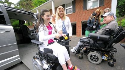 A gleeful Miranda Guerino, 16, left, and her mom, Melissa, trying out the family's new, anonymously donated, wheelchair-equipped van. Miranda's father, Gary, left, watches from the driveway of their Richland home.