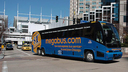 A Megabus in 2007 leaves the stop under David L. Lawrence Convention Center for its first Pittsburgh trip at 10th Street turning onto Liberty Avenue.