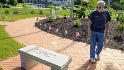 Moon Fire Marshal Charlie Belgie walks past one of the new benches at the 911 Memorial Garden at the Moon Township Municipal Building along Beaver Grade Road.