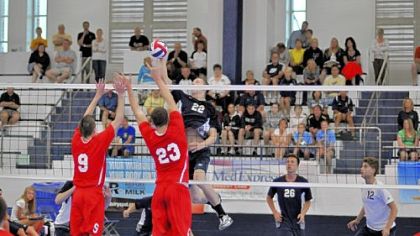 Norwin's Nate Derry leaps to spike a shot against Chambersburg in the PIAA Class AAA tournament semifinals last Saturday at Penn State.