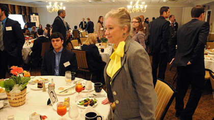 Sherry Szakelykidi of Henfren-Tilotson gets up from one of the tables as she moves onto the next table during a job fair at the Rivers Club at Oxford Center.