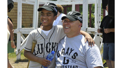 Josiah Vaughn, left, 10, of Crafton Heights and Clairton police Officer James Kuzak pose at the first Heroes Game.
