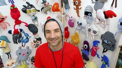 Daniel Baxter stands with some of his "Kreepy Dolls" at his booth at the Three Rivers Arts Festival.