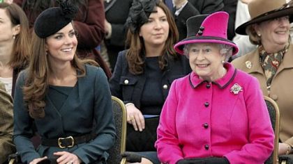 Britain's Queen Elizabeth II, right, and Catherine, Duchess of Cambridge, watch a fashion show at De Montfort University in Leicester, England. When it comes to fashion, Queen Elizabeth II is the defining image of royalty.