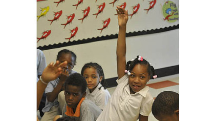 Makita Carter raises her hand during a morning meeting of third-graders in May at Faison K-5 in Homewood.