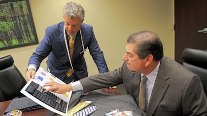 Robert Engel, left, of Tom James Co., shows samples to Emanuel DiNatale, chairman of accounting firm Alpern Rosenthal, at his office, Downtown.