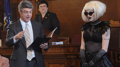 Councilman Patrick Dowd reads a proclamation he sponsored honoring drag queen Sharon Needles, right, during a city council meeting Tuesday. In the background is council President Darlene Harris.