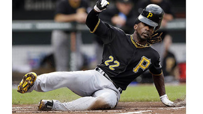 Pirates outfielder Andrew McCutchen loses his helmet as he slides into home plate for a run on a single by Matt Hague in the first inning Tuesday night in an 8-6 loss to the Baltimore Orioles.