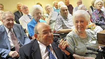 At a ceremony honoring couples married for 50 years or longer at St. Barnabas last Thursday, Charles Cannoni talks about how he met his wife Lena, right. The Cannonis have been married for 65 years and were celebrating their anniversary, having wed on June 7, 1947.