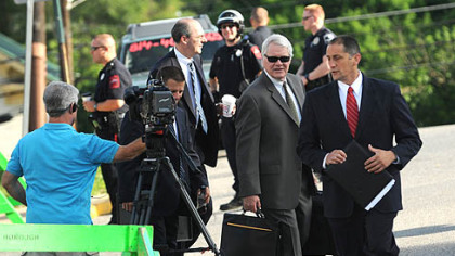 The prosecutor in the Sandusky case, Joseph E. McGettigan III, center, outside the Centre County Courthouse.