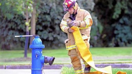 Capt. Allen Morrow, volunteer firefighter from Moon, hooks up the hose to the hydrant during a pump practice drill.