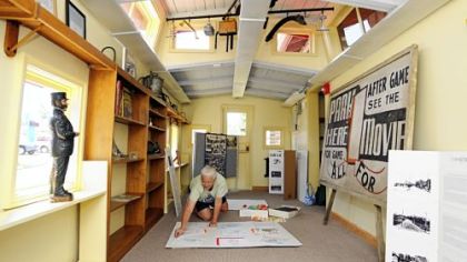 Volunteer Daria Lacey puts together a display of kids artwork in the "caboose" of the new home of the Bridgeville Historical Society.  The society took over an old railroad car that was the library.
