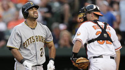 The Pirates' Pedro Alvarez, left, reacts after he struck out swinging to end the second inning. Orioles catcher Matt Wieters, right, looks on.
