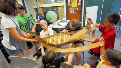 Fourth-grade students in Martin Richter?s class (from left: Abigail Begler, Zack Dickinson, Jenna Pieretti, Rebekah Froehlich, Nadia Huebner, Ethan Vechi and Bethany Wittig) at West View Elementary School made a replica of a Viking longboat. They are finishing a second one as the school year ends. West View Elementary is in the North Hills School District.