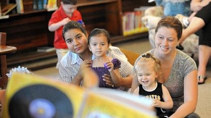Awantika Kumar, left, of Carnegie, her 2-year-old daughter, Aarna, 15-month-old Elizabeth Glance and her nanny, Jennifer Matta, 28, attend a story-telling session at the Andrew Carnegie Library.