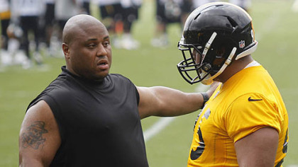 Veteran Casey Hampton, left, explains something to rookie Alameda Ta'amu during the team's minicamp this week.