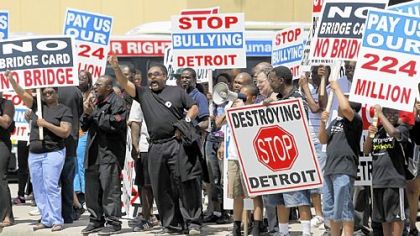 People in Detroit protest a new bridge on Friday that will be built between Ontario and Detroit.