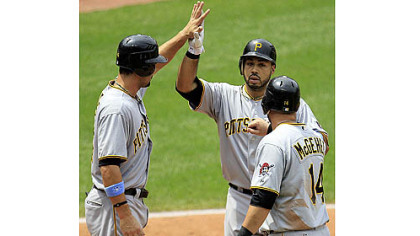 The Pirates' Pedro Alvarez, center, is congratulated by teammates Garrett Jones, left, and Casey McGehee after hitting a three-run home run off Cleveland Indians starting pitcher Jeanmar Gomez in the fourth inning.