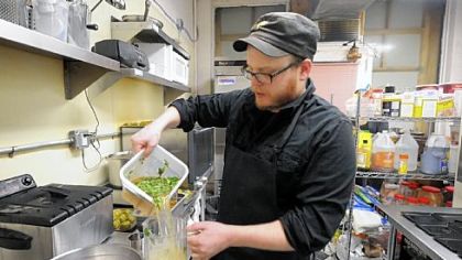 Robert Sayre cooking for a Conflict Kitchen fundraiser in February in the kitchen it shares with the Waffle Shop in East Liberty.
