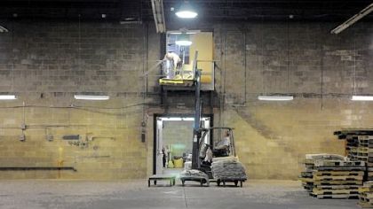 Workers place furniture in storage at a warehouse once used by IGA earlier this month in Republic. The Fayette Community Action Council now owns the building and hopes to turn it into a place where locally grown food is processed.