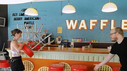 Courtney Ehrlichman and Robert Sayre arrange the stools at the Waffle Shop in East Liberty, next to Conflcit Kitchen.