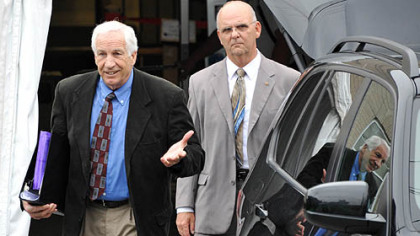 Jerry Sandusky leaves the Centre County Courthouse Monday, following the fifth day of testimony in his trial. At right is Centre County Sheriff Denny Nau.