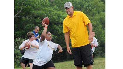Steelers quarterback Ben Roethlisberger gives instruction in passing to youths during workouts at his football camp at Seneca Valley High School.