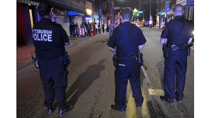 Pittsburgh police officers shut down East Carson Street between 11th and 12th Streets to keep crowds from gathering and blocking traffic outside the Caravan Club.