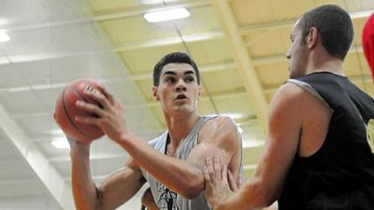 Stephen Adams, left, a Pitt basketball recruit from New Zealand, looks to the basket during a Pittsburgh Pro-Am summer league game at the Greentree Sportsplex.