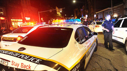 Pittsburgh police officers use loud sirens to disperse a crowd at 18th Street and East Carson Street on the South Side.