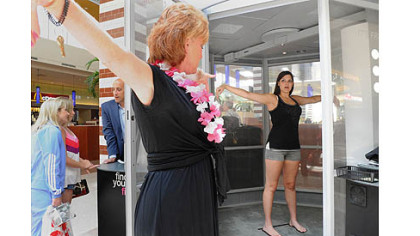 Denise Zambarano, left, of Me-Ality gives instructions to Susan Fancsali, 19, of Pleasant Hills before scanning her body at The Mall at Robinson.