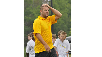 Steelers quarterback Ben Roethlisberger watches youths work out at his football camp.