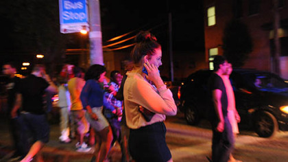 Pittsburgh police officers use loud sirens to disperse a crowd at 18th Street and East Carson Street on the South Side.