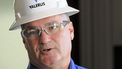 Valerus regional vice president Chris Scheve talks about safety precautions during a media tour. Left, an electronic sign updates consecutive safe days.