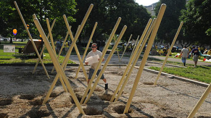 Mike Jeffrey of Indiana Township and with Jeffrey Associates, walks through a maze of poles at the new KaBOOM! playground at Allegheny Commons Park on the North Side.