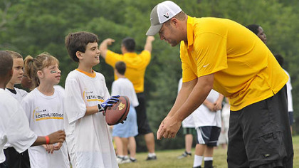Ben Roethlisberger gives instructions to youths during workouts at his football camp at Seneca Valley High School.