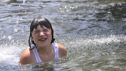 Jasmine Rosak, 10, of Glassport, cools off in the fountain near the Frick Fine Arts Center in Schenley Park.