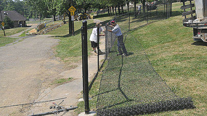 Workers from Allegheny Fence work on the new dog park at Olympia Park on Mount Washington today.