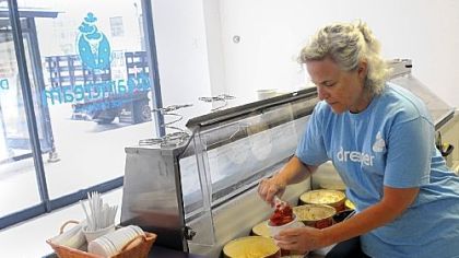 Naomi Herman, a volunteer for the American Liver Foundation, dishes up red velvet ice cream at  Dream Cream, a pop-up ice cream store on Liberty Avenue, Downtown.