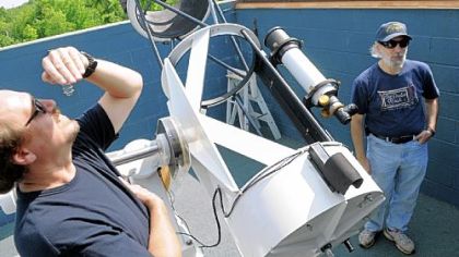 Tom Reiland, right, director of the Nicholas E. Wagman Observatory, explains the 21-inch Manka Memorial Telescope while Bill Yorkshire sneaks a peak at the sun.