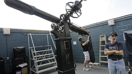 Bill Yorkshire, left, and Tom Reiland prepare the observatory's Brashear 11-Inch Refractor for use.