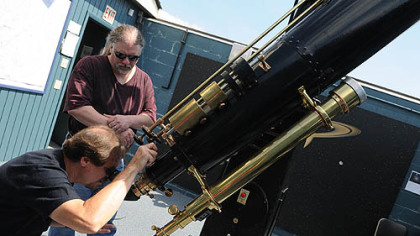 Rowen Poole and Bill Yorkshire, associate directors at Wagman Observatory, prepare the Brashear 11-Inch Refractor to view sunspots.