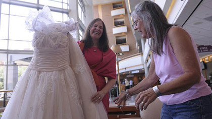 Elissa Ashwood, left, a cancer patient from Squirrel Hill, meets three-time cancer survivor Ava Kundman, of New Eagle, and gives her a dress Wednesday at Magee-Womens Hospital of UPMC. Ms. Ashwood raffled off the dress to encourage cancer survivors to live life to the fullest. During her 33 days of radiation treatment she wore a different dress to try to change her outlook about treatment.