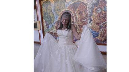 Three-time cancer survivor Ava Kundman shows off the dress she won through the 33 Dresses project Wednesday at Magee-Womens Hospital of UPMC.