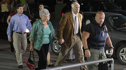 Former Penn State University assistant football coach Jerry Sandusky, right center, arrives with his wife Dottie, left center, at the Centre County Courthouse tonight to learn of the jury's decision.
