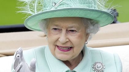 Queen Elizabeth II warms up her pitching arm (in fact, waving to the crowd at the Royal Ascot horse race on June 21).