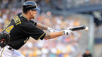 The Pirates' A.J. Burnett puts down a bunt against Detroit at PNC Park last night.
