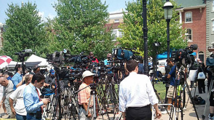 Members of the media gather early Friday morning outside the Centre County Courthouse in Bellefonte.