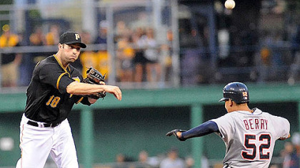 The Pirates' Neil Walker checks off Detroit's Quintin Berry in the top half of a double play last night at PNC Park.
